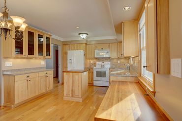 Kitchen remodel with hickory cabinets, quartz and walnut counter tops. Maple floors