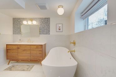 Luxury En Suite Bath remodel with penny round tiles and soaker tup, gold plumbing fixtures