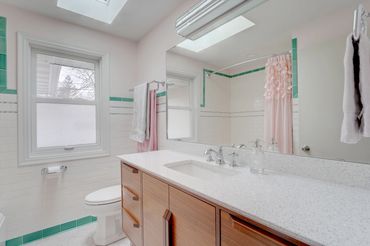 Mid Century Modern bathroom remodel with Cambria Whitney.  Pink and Tourquoise accents.