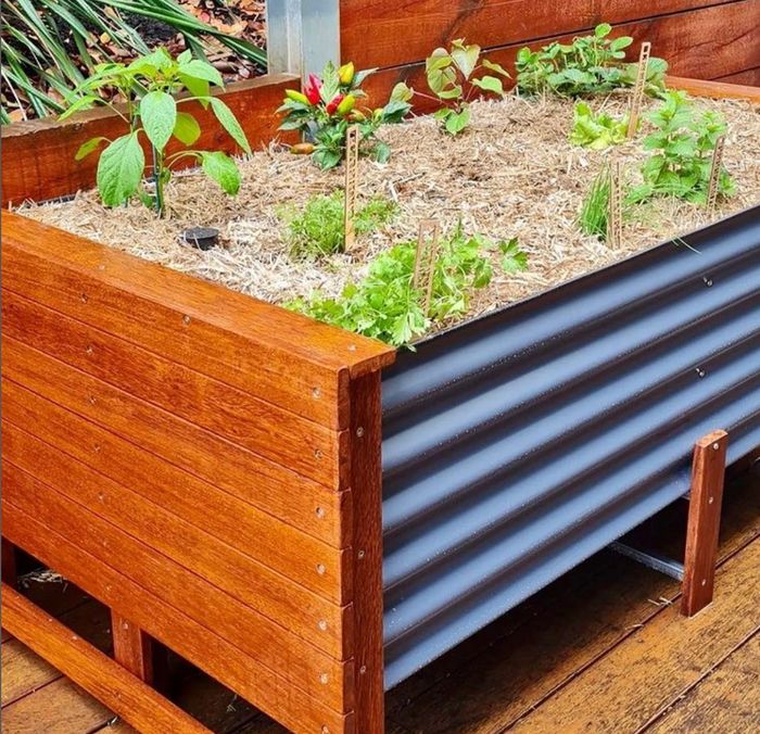 Sustainable herb planter box garden bed with self watering wicking system and composting worm farm