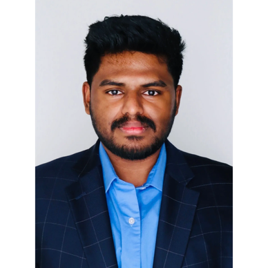 Professional portrait of a man in a blue shirt and dark blazer.