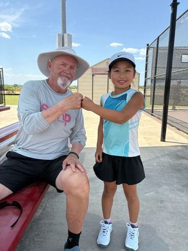 SCHP Tennis coach with a young player on court in Georgetown, TX