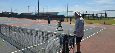 SCHP Tennis coach training junior players on court in Georgetown, TX