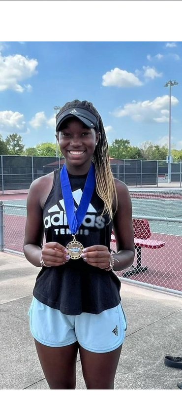 SCHP Tennis player smiling with tournament medal on court