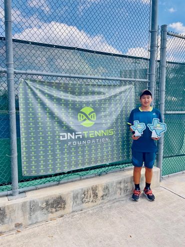 SCHP Tennis player with Texas-shaped trophies at DNA Tennis Foundation event