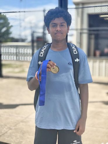 SCHP Tennis player proudly holding a gold tournament medal
