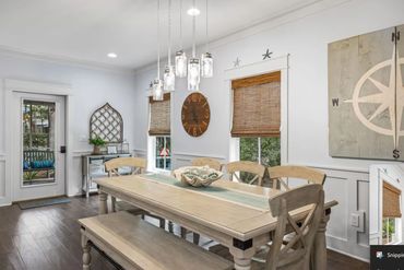 Cozy dining room with rustic wooden table, bench, and wicker window blinds.