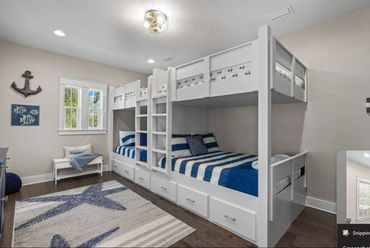 Nautical-themed bunk bed room with blue and white decor and starfish rug.