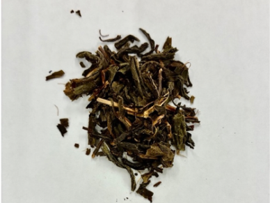 Dried loose tea leaves on a white background.