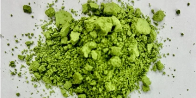 Green powder on a white surface.
