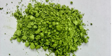 Bright green powder on a white surface.