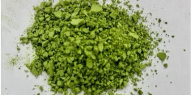 Crushed green powder on a white surface.