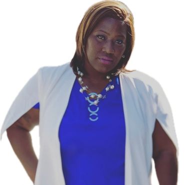 Confident woman in a white outfit and blue top with a statement necklace.