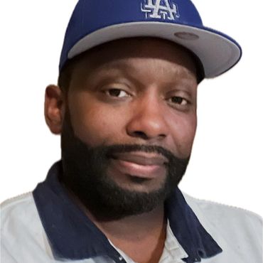 Man wearing a blue LA cap and a white polo shirt giving a thumbs up.