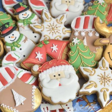 Assorted decorated Christmas cookies with Santa, snowmen, and trees.