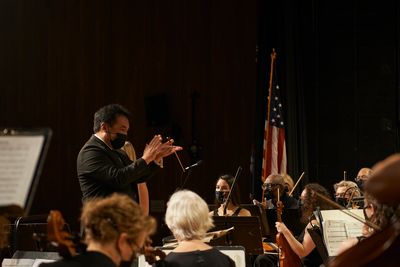 Steven Huang conducting a NewWSO performance in 2022