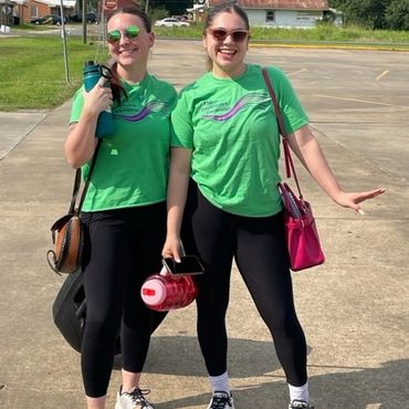 Two girls standing in parking lot.