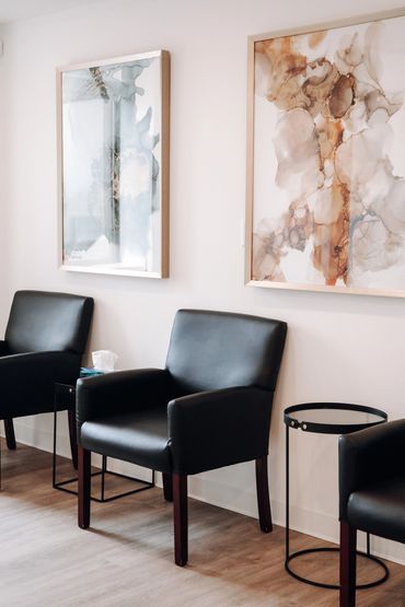 Vancouver chiropractor RMT Reception area with seats and wall art.