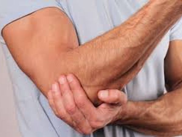 Person holding elbow in pain.