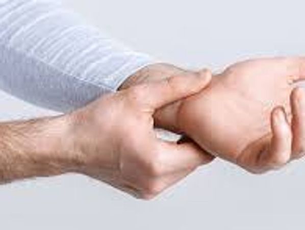Person holding wrist in pain.