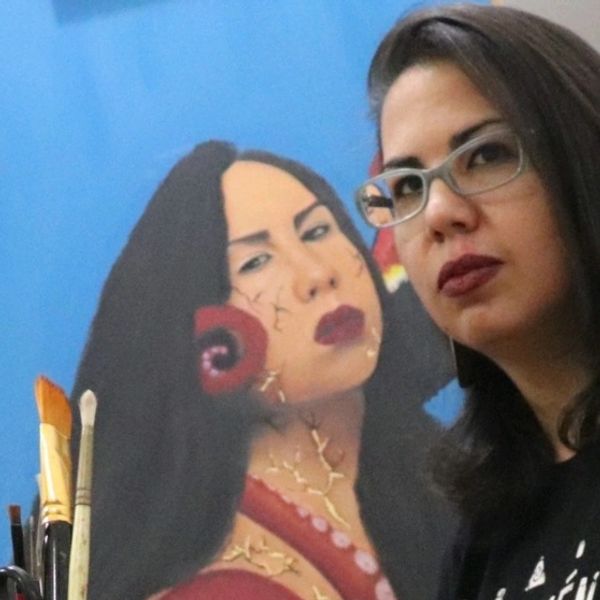 Latina Artist Vanessa Peters, The Brooklyn Buddha with her self portrait painting.  Oil Painting.