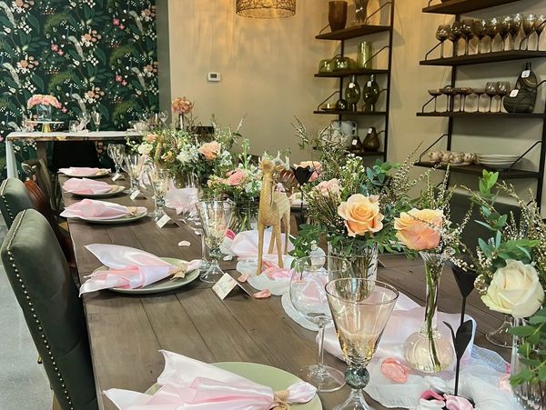 Elegant dining table set with floral centerpieces and soft lighting.