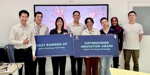 Group holding awards for MDCU Pitching Challenge achievements.