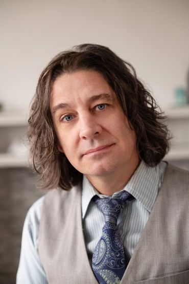 Business professional posing for camera in natural setting