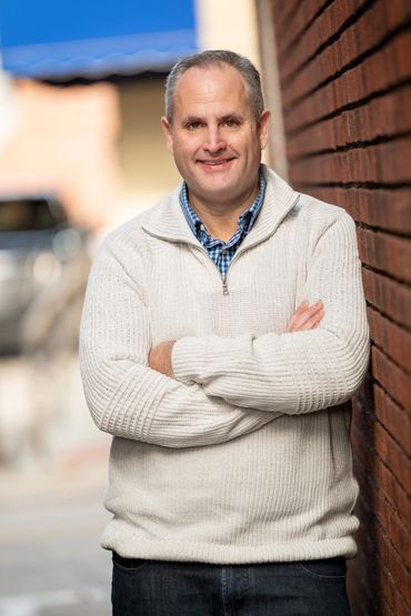 Business professional posing for camera in natural setting