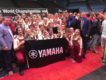 Group photo of a Yamaha-sponsored team celebrating at World Championships.