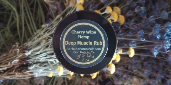 jar of muscle rub salve for pain , balm, placed on lavender flowers