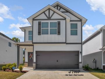 Modern two-story house with a large garage.