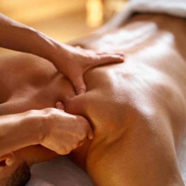 Person receiving a deep tissue back massage.