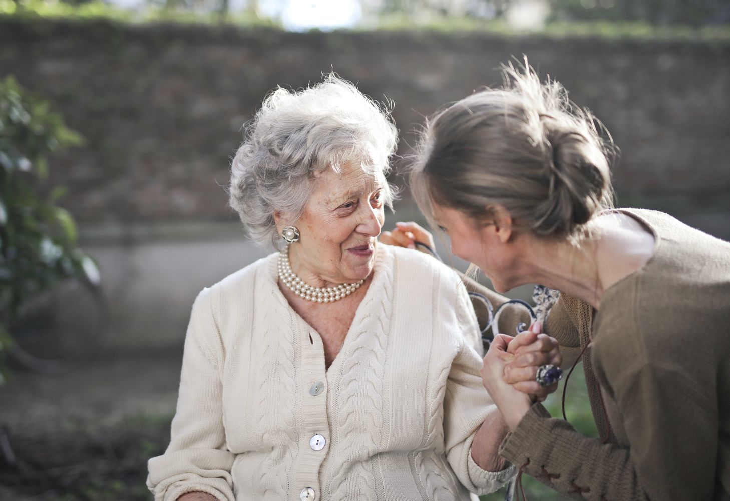 A healthcare professional offering companionship to an elderly woman
