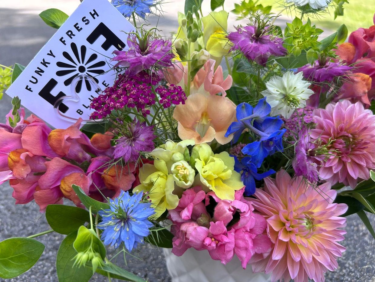 Colorful mixed flower bouquet with a Funky Fresh Blue tag.