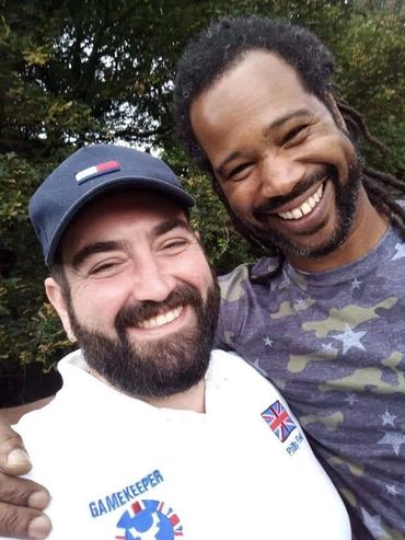 Two happy men smiling outdoors.