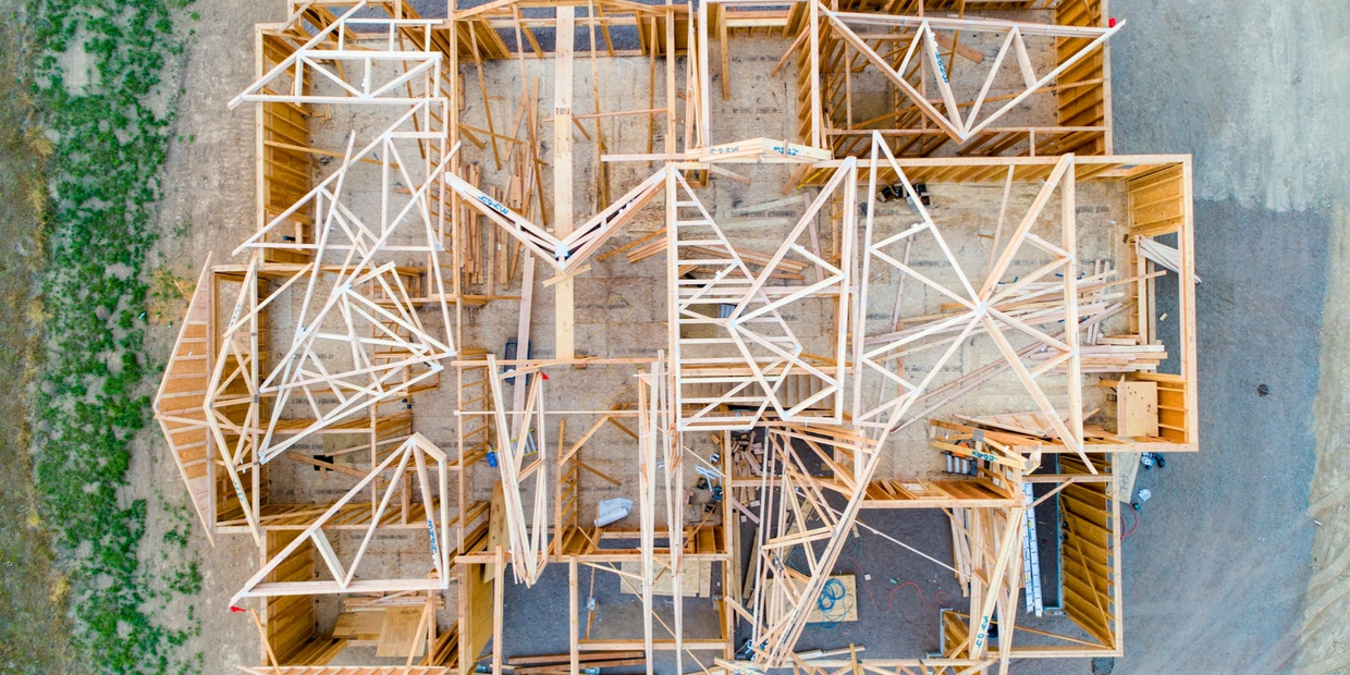 Aerial view of wooden framing for a house under construction.