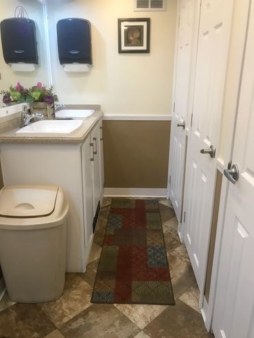 8 stall restroom trailer interior- female- with 2 sinks and 3 stalls.