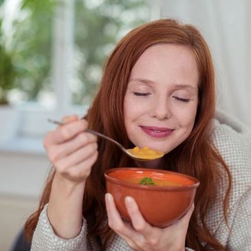 Lady enjoying bowl of delicious soup