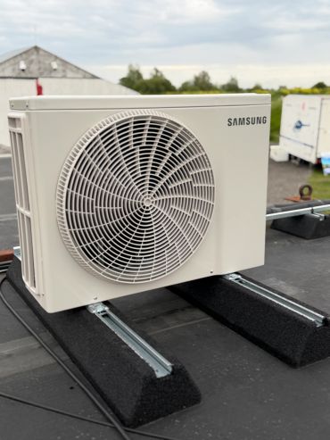 Outdoor Samsung air conditioning unit installed on a rooftop.