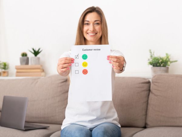 Woman giving best estimation for cleaning sofa in living room, copy space