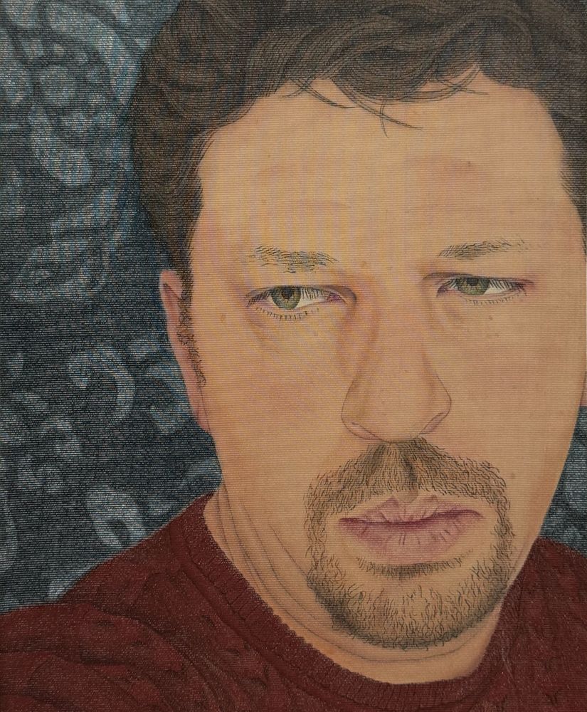 Realistic portrait of a man with green eyes and a red sweater against a textured background.