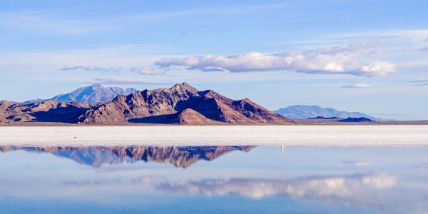 Mountains reflected in a calm body of water.