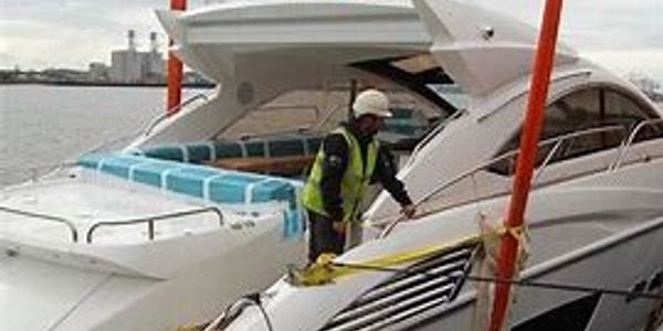 A powerboat being lifted out of the water
