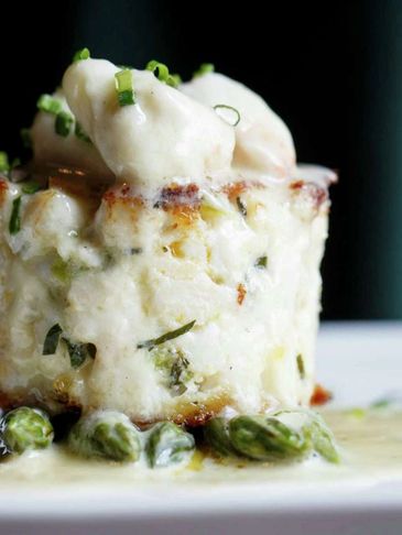 Creamy seafood gratin with herbs, peas, and scallops.