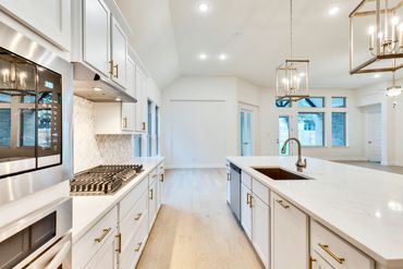 Real estate photography for Austin homes, kitchen, island, lights, luxury