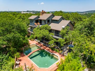 Drone footage of Austin residential area, luxury home, skyline, pool