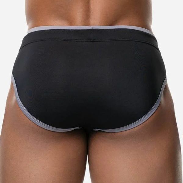 Back view of person wearing black briefs with grey trim.