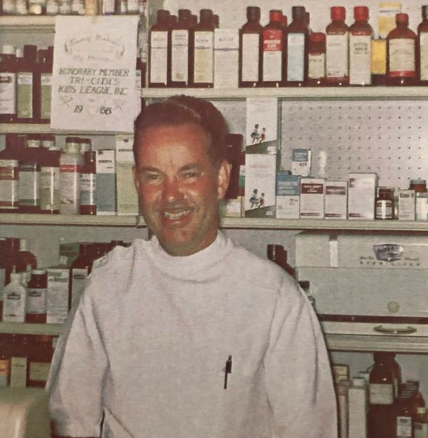 Image: Clifford Pfaff stands in front of prescription bottle circa 1957