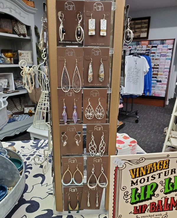 Image: assorted gifts showcasing earrings in foreground